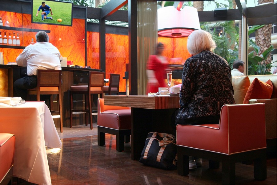 a woman sitting on a chair in a restaurant 