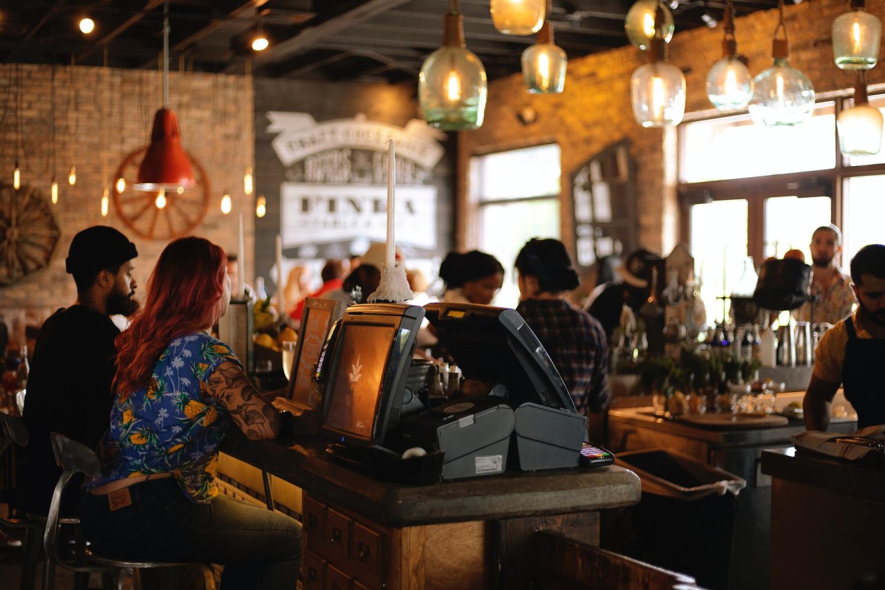 A busy restaurant cafe shown from behind the counter. 